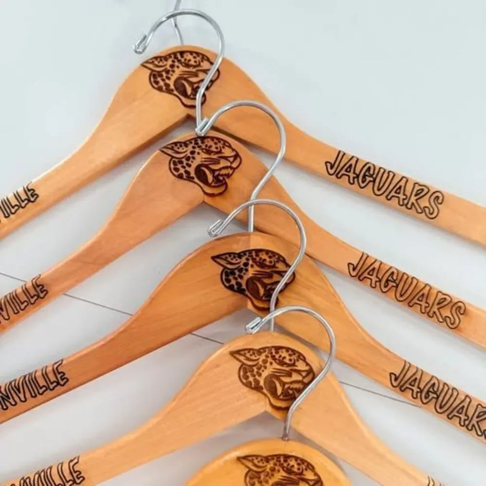 5 custom wood hangers with Jacksonville Jaguars branding.